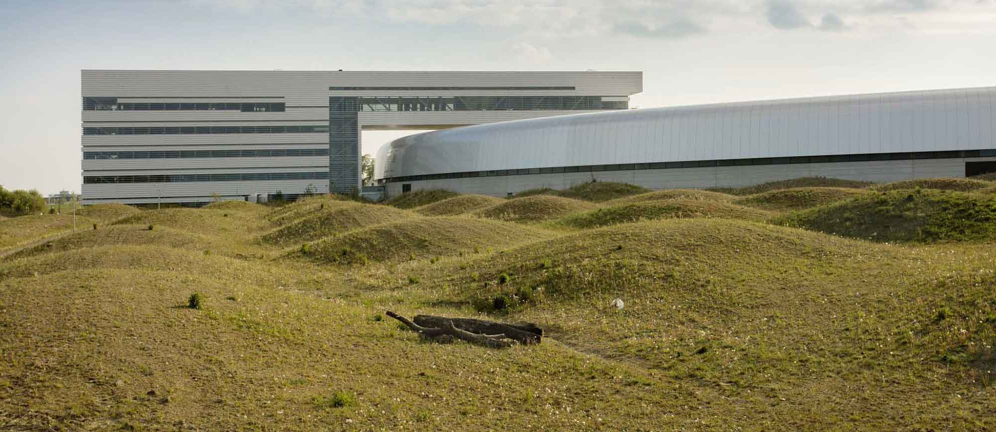 The MAX Lab facility uses a rippled spiral of topographic form to surround the main building.